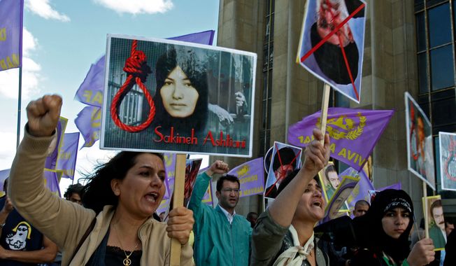 Supporters of National Council of Resistance of Iran in France protest the death sentence of Sakineh Mohammadi Ashtiani, at Trocadero square in Paris, Saturday, Aug. 28, 2010. Ms. Ashtiani, a 43-year-old mother of two, was sentenced to death by stoning for adultery. (AP Photo/Michel Euler)