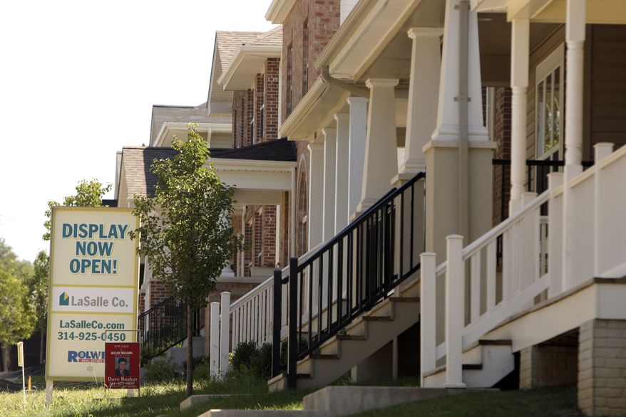 In this Aug. 24, 2010, photograph, a row of new homes is seen in the Boulevard Heights development in St. Louis. Home prices rose in June for the third straight month amid a burst of home-buying due to tax incentives that have since expired. (AP Photo/Jeff Roberson)