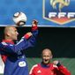 Zinedine Zidane waves with his shoes after his visit to France soccer team players during their training session in Clairefontaine, southwest of Paris Wednesday, Sept 1, 2010 ahead of their opening Euro 2012 qualifiers.(AP Photo/Francois Mori)