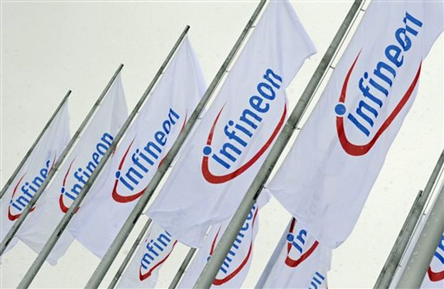 FILE - In this Feb. 12, 2009 file photo, flags with the company logo of Infineon Technologies are seen prior to the annual shareholders meeting in Munich, southern Germany. German chipmaker Infineon Technologies AG is selling a unit that makes products for wireless telephones to California's Intel Corp. in a $1.4 billion cash deal, the companies said Monday, Aug. 30, 2010. (AP Photo/Uwe Lein, File)