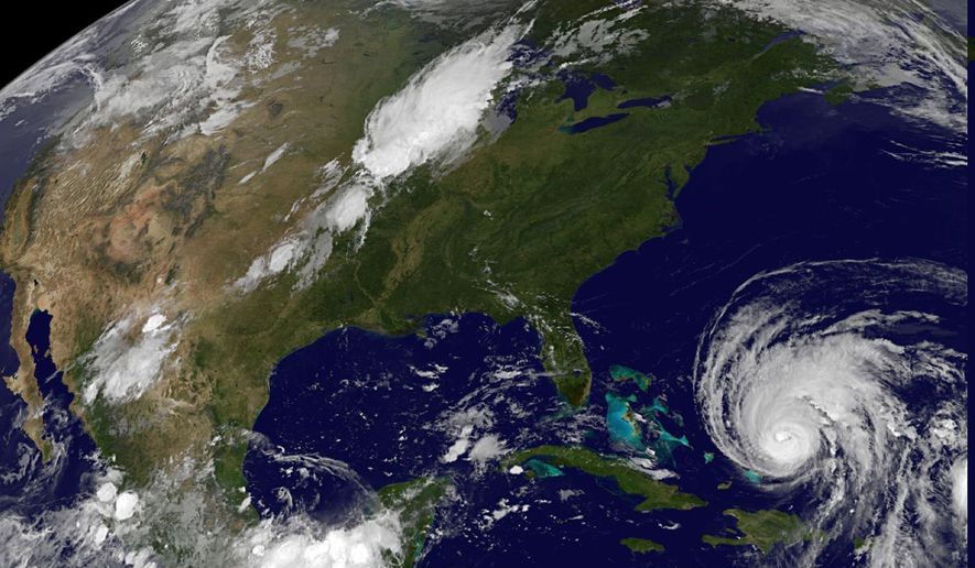 This image provided by the National Aeronautics and Space Administration shows Hurricane Earl (lower right) at 1 a.m. EDT on Wednesday, Sept. 1, 2010. At 11 p.m. EDT Tuesday the center of the storm was located about 910 miles south-southeast of Wilmington, N.C. The Category 4 hurricane was moving northwest at 15 mph with maximum sustained winds of 135 mph. (AP Photo/NASA)