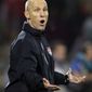 FILE - IN a June 12, 2010, file photo, U.S. soccer coach Bob Bradley gestures during a World Cup group C match between England and the United States at Royal Bafokeng Stadium in Rustenburg, South Africa. Bradley will remain coach of the U.S. men&#39;s soccer team through the 2014 World Cup. U.S. Soccer announced late Monday, Aug. 30, 2010, it had agreed to a four-year contract extension with Bradley, whose current deal expires in December. (AP Photo/Elise Amendola, File)