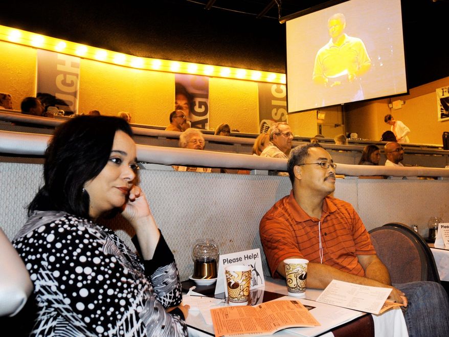 Angela Cain-Crawford and her husband, George Crawford, listen to a speaker at the dinner-theater service. A recent survey by the United Methodist Church finds variety helps churches grow.