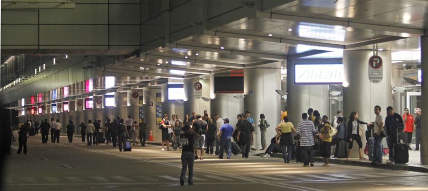 Passengers head out of the terminal at Miami International Airport early Friday morning, Sept. 3, 2010. A spokesman for the airport said four of its six concourses were evacuated as a police bomb squad investigated a report of a suspicious item. Several flights were diverted to other parts of the terminal.(AP Photo/Alan Diaz)