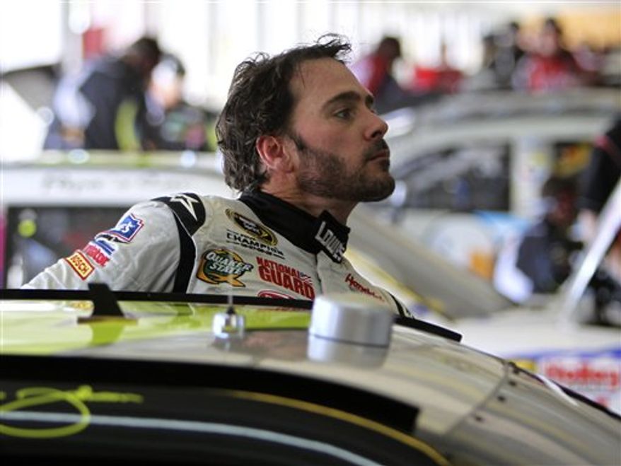 Crew memebrs work on Tony Stewart's car during the NASCAR Sprint Cup Series auto race at Atlanta Motor Speedway in Hampton, Ga., Sunday, Sept. 5, 2010. Stewart won the race. (AP Photo/Glenn Smith)