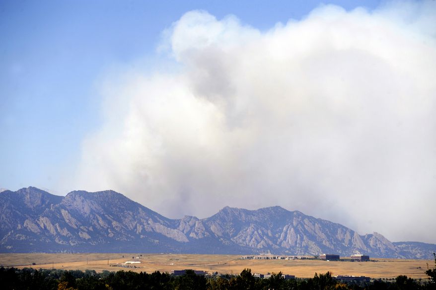 Smoke from a wildfire that broke out on Monday, Sept. 6, 2010, fills the sky in the mountains between Four Mile Canyon and Left Hand Canyon northwest of Boulder, Colo. (AP Photo/Denver Post, Kathryn Scott Osler)