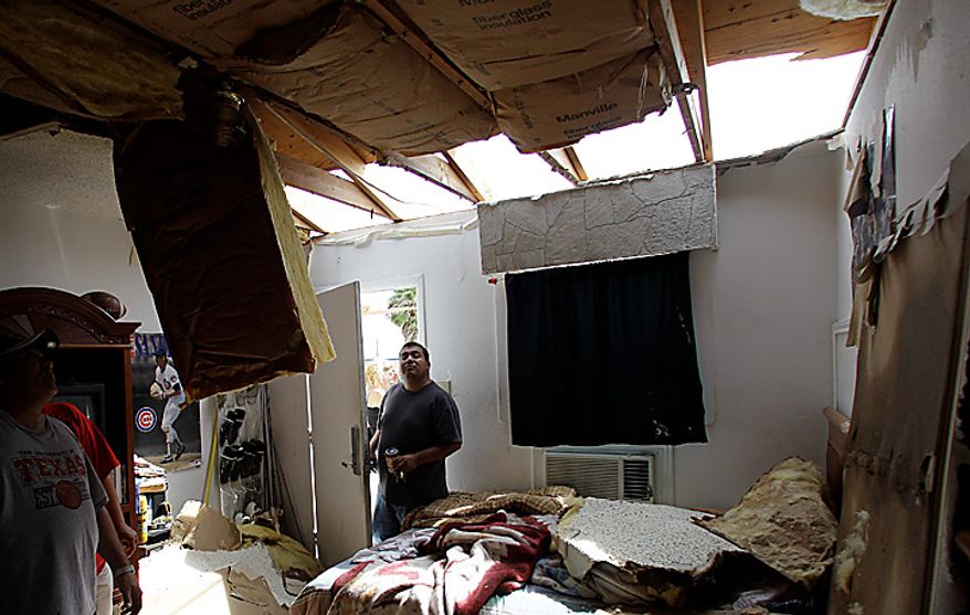 Manager Juan Cortez surveys a room at his motel, Tuesday, Sept. 7, 2010 in Raymondville, Texas. The motel lost a portion of its roof when tropical storm Hermine swept through the area. (AP Photo/Eric Gay)