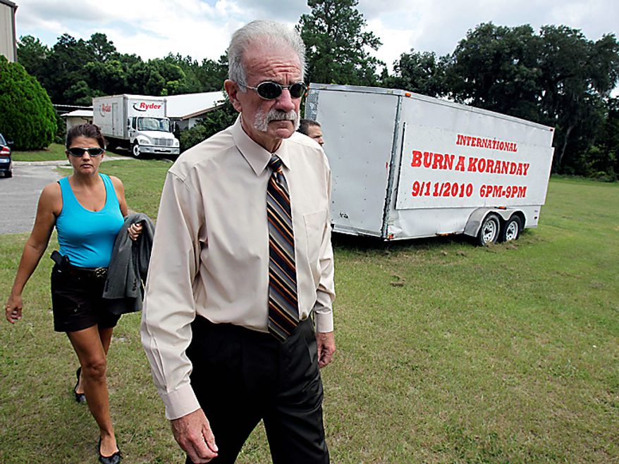 Pastor Terry Jones, right, of the Dove World Outreach Center arrives at a news conference with an armed escort in Gainesville, Fla., Wednesday, Sept. 8, 2010. Jones stated that he is going forward with a scheduled burning of copies of the Quran at his church on Saturday, Sept. 11. (AP Photo/John Raoux)