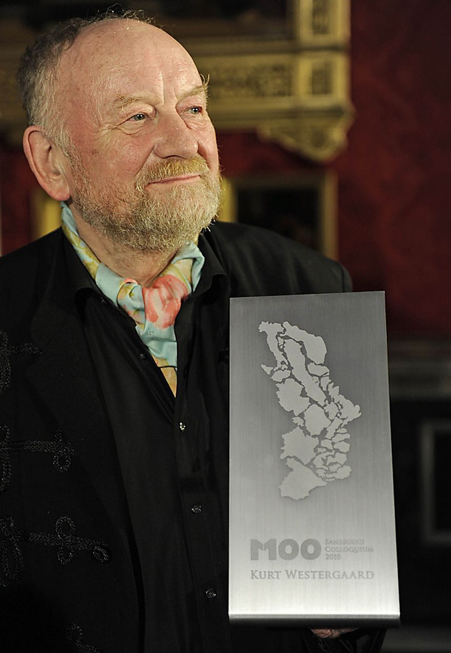 Danish cartoonist Kurt Westergaard shows off his award after receiving the M100 Media Prize 2010 in Potsdam near Berlin, eastern Germany, Wednesday, Sept. 8, 2010. Westergaard drew the most controversial of 12 caricatures of the Prophet Mohammed, first published in a Danish newspaper in 2005, which many Muslims considered offensive. (AP Photo/Odd Andersen, pool)