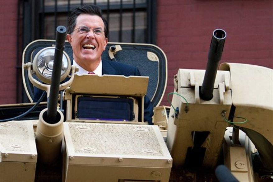 Stephen Colbert rides an Army ASV while taping an episode of the Colbert Report on West 54th Street in New York, Wednesday, Sept. 8, 2010. (AP Photo/Charles Sykes)