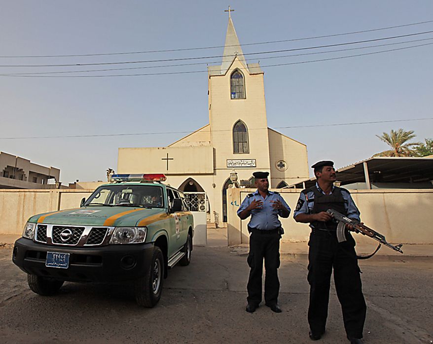 Iraqi policemen stand guard outside Evangelical Protestant church in Baghdad, Iraq, Thursday, Sept. 9, 2010. There are fears of a backlash against Christians in predominantly Muslim countries. Canon Andrew White, the chaplain of an Anglican church in Baghdad, said the Iraqi military had warned him that his church had been threatened. Security was beefed up around the Church of Virgin Mary in central Baghdad on Thursday, with military vehicles blocking the entrance to the church and more soldiers were deployed to guard it. (AP Photo/Khalid Mohammed)