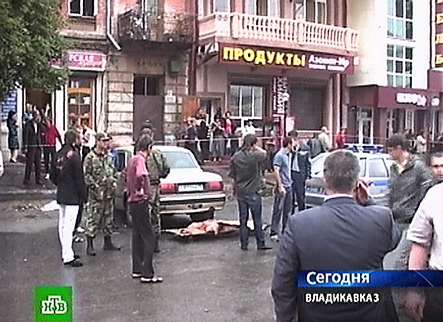 In this image made from television, cars damaged in a suicide car attack are seen in a square outside a market in Vladikavkaz, North Caucasus, Russia, Thursday, Sept. 9, 2010. A suicide car bomber hit the central market of Vladikavkaz on Thursday, killing more than a dozen and wounding more than 130 people in one of the worst terror attacks in the volatile region in years, officials said. (AP Photo/NTV Russian Channel)