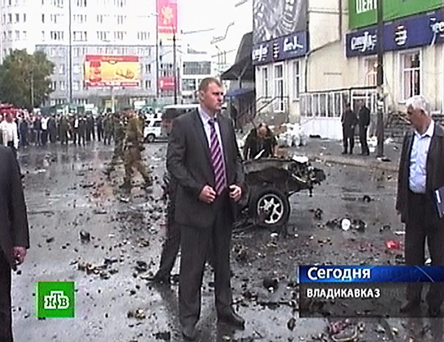 In this image made from television, the wreckage of a car destroyed in a suicide car attack is seen in a square outside a market in Vladikavkaz, North Caucasus, Russia, Thursday, Sept. 9, 2010. A suicide car bomber hit the central market of Vladikavkaz on Thursday, killing more than a dozen and wounding more than 130 people in one of the worst terror attacks in the volatile region in years, officials said. (AP Photo/NTV Russian Channel)