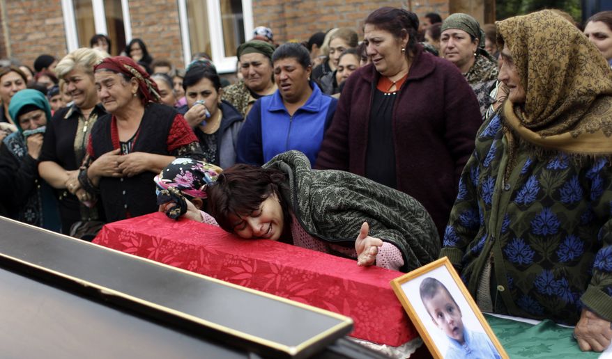 Relatives mourn Elnuz Ashimov, 7, who was killed in suicide bombing on Thursday at the central market in Vladikavkaz, North Caucasus, Friday, Sept., 10, 2010. Thursday's bombing near the central market of the capital of the North Ossetia republic was the most serious attack in Russia since the March subway bombings in Moscow that killed 40 people. (AP Photo/Sergey Ponomarev)