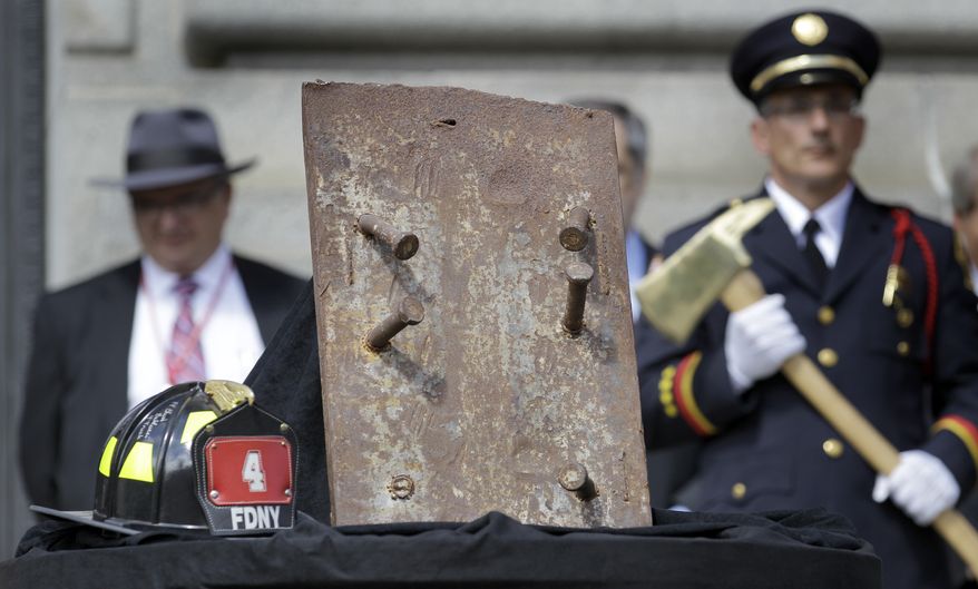A piece of steel from the World Trade Center and a helmet signed by surviving members of New York City Fire Department Station 4 sit front and center at the City of Cleveland Patriot Day Ceremony, this year honoring in particular those who lost their lives in the terrorist attacks of Sept. 11, 2001, in Cleveland on Friday, Sept. 10, 2010. Saturday marks the 9th anniversary of the attacks. (AP Photo/Amy Sancetta)