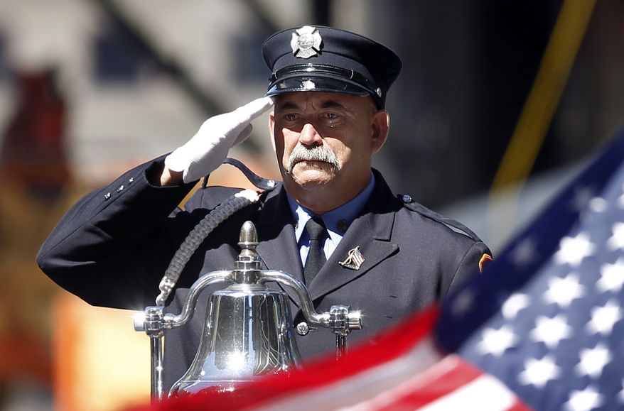 A firefighter salutes as taps is played for victims of the Sept. 11, 2001, attacks, during a commemoration ceremony at Zuccotti Park, adjacent to ground zero, on the ninth anniversary of the terrorist attacks on the World Trade Center on Saturday, Sept. 11, 2010, in New York. (AP Photo/Jason DeCrow)