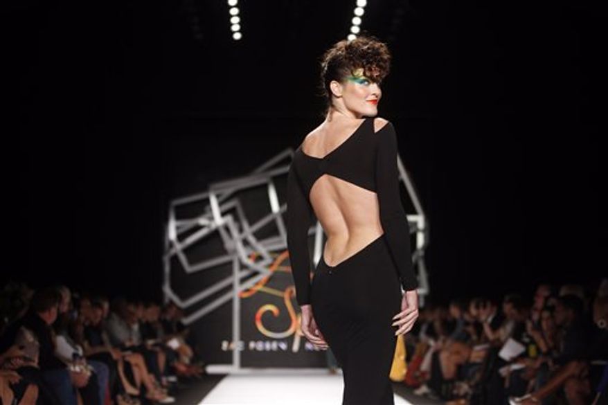 Designer Zac Posen acknowledges the audience after the Z Spoke by Zac Posen spring 2011 collection show Saturday, Sept. 11, 2010, during Fashion Week in New York. (AP Photo/Jason DeCrow)