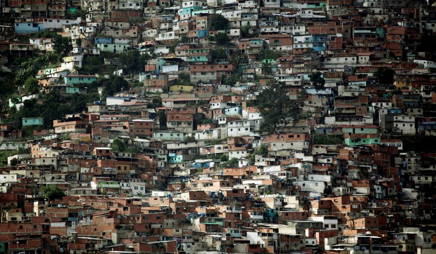 Shacks made of wood scraps and corrugated zinc dominate a slum of Caracas, Venezuela, but the government says it has halved the country's poverty rate. (Associated Press)