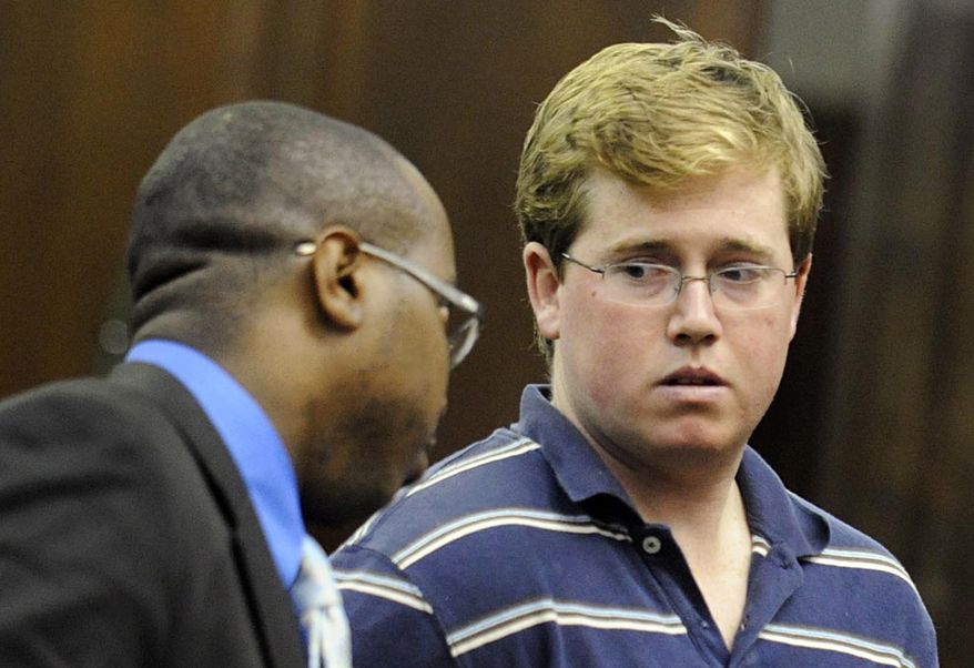 In this Aug. 25, 2010 ,file photo, Michael Enright, right, confers with his attorney Jason Martin, during his arraignment in a New York City courtroom. Defense lawyer Lawrence Fisher says Mr. Enright, a student accused of cutting a Muslim taxi driver's neck in New York City has post-traumatic stress disorder and chronic alcoholism. A Manhattan judge said Monday Sept. 13, 2010, he'll decide at arraignment whether to grant bail for Enright, who is accused of attacking the driver with a folding knife last month. (AP Photo/Steve Hirsch, Pool, File)