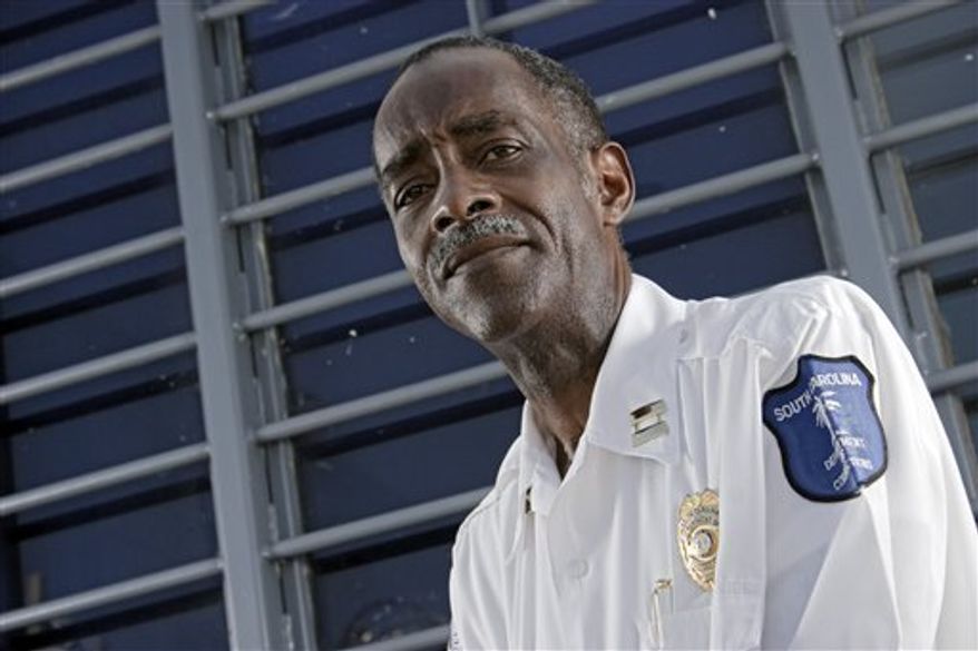 In a Wednesday, Sept. 1, 2010 photo, Capt. Robert Johnson, right, talks with Lloyd Greer, left, who investigated a plot to kill Johnson, at the Lee Correctional Institution, in Bishopville, S.C. where Johnson was in charge of preventing contraband from entering the prison. Johnson was was nearly killed at his home in an attack planned with an inmate's smuggled cell phone. (AP Photo/Brett Flashnick) (AP Photo/Brett Flashnick)