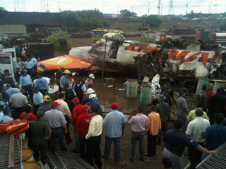 In this image courtesy of Globovision Television News, people surrounds the wreckage of an airplane of a state airline Conviasa after it crashed about 6 miles from the eastern city of Puerto Ordaz, Venezuela, Monday, Sept. 13, 2010. The plane was carrying 51 people, and officials said at least 33 people survived.(AP Photo/Globovison)