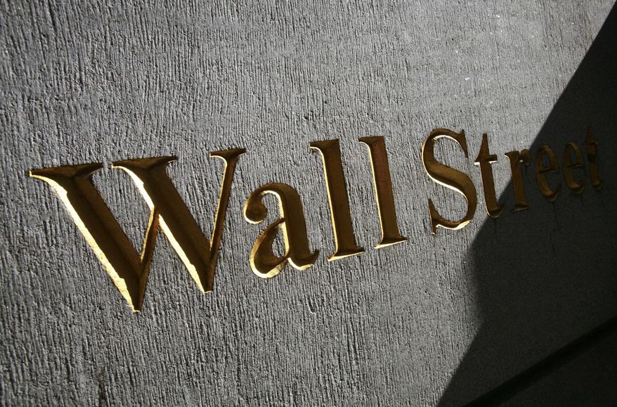 March 8, 2010, file photograph of a sign for Wall Street near the New York Stock Exchange. Stock futures are rising sharply Monday, Sept. 13, as investors gain confidence in the banking sector following the passage of new global regulations and China's economy continues its robust growth. (AP Photo/Mark Lennihan, file)