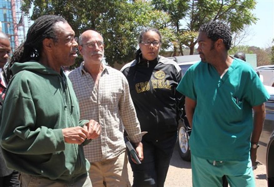 American doctors, from left, Gregory Reinard, David Greenburg, Gloria Cox Cronwell and Anthony Eugene Jones appear at the magistrates courts in Harare, Zimbabwe Monday, Sept. 13, 2010. The four were charged under Zimbabwean laws for practising medicine and selling drugs without a licence. They were released on bail after paying $200 each and could face a fine and deportation. The California church that sponsors their work says the church has been working in Zimbabwe for more than a decade and that this is the first time licensing questions have been raised. (AP Photo/Tsvangirayi Mukwazhi)