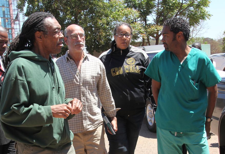 American doctors, from left, Gregory Reinard, David Greenburg, Gloria Cox Cronwell and Anthony Eugene Jones appear at the magistrates courts in Harare, Zimbabwe Monday, Sept. 13, 2010. The four, charged under Zimbabwean laws for practising medicine and selling drugs without a license, were released on bail after paying $200 each and could face a fine and deportation. (AP Photo/Tsvangirayi Mukwazhi)