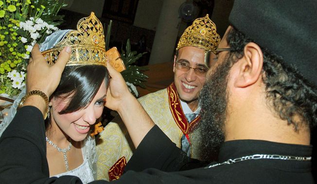 Irini Ibrahim (left) and Rizk Kands are married on Oct. 14, 2008, by Coptic priest Bejemeni Shawki in Alexandria, Egypt. In April, Ibrahim was found murdered in a hotel room she and her husband had reserved after &quot;reconciliation sessions.&quot; (Associated Press)