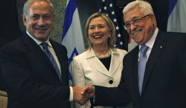 Israeli Prime Minister Benjamin Netanyahu, left, shakes hands with Palestinian Authority President Mahmoud Abbas, second right, joined by Secretary of State Hillary Rodham Clinton, center during bilateral talks at the Red Sea resort of Sharm el Sheik, Egypt Tuesday Sept. 14, 2010. (AP Photo/Nasser Nasser)