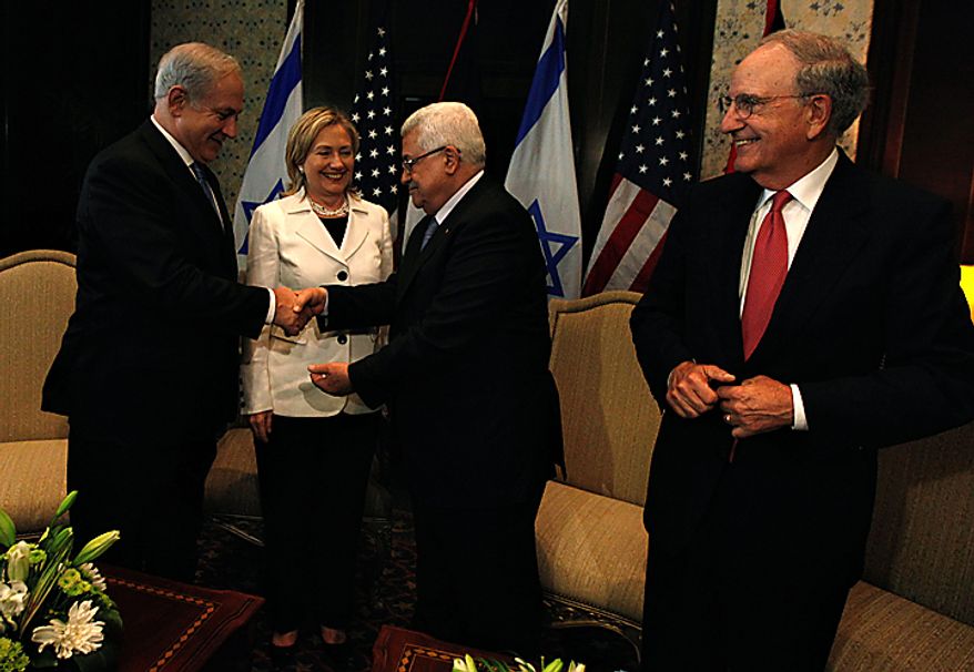 Israeli prime minister Benjamin Netanyahu, left shakes hands with Palestinian president Mahmoud Abbas, second right joined by U.S. secretary of state Hillary Rodham Clinton, second left and U.S. Middle East envoy George Mitchell, right during their bilateral talks at the Red Sea resort of Sharm el-Sheik, Egypt Tuesday Sept. 14, 2010. The most immediate dispute between the two sides surrounds the current Sept. 26 deadline on restriction of new construction for Israeli settlers in the West Bank. (AP Photo/Nasser Nasser)