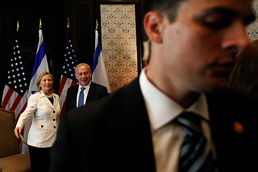 Security officers, right, move media personnel out of the room after a photo opportunity during the meeting of U.S. secretary of state Hillary Rodham Clinton, left, with Israeli prime minister Benjamin Netanyahu, center, at the Red Sea resort of Sharm el-Sheik, Egypt, Tuesday Sept. 14, 2010. The most immediate dispute between the two sides surrounds the current Sept. 26 deadline on restriction of new construction for Israeli settlers in the West Bank. (AP Photo/Nasser Nasser)