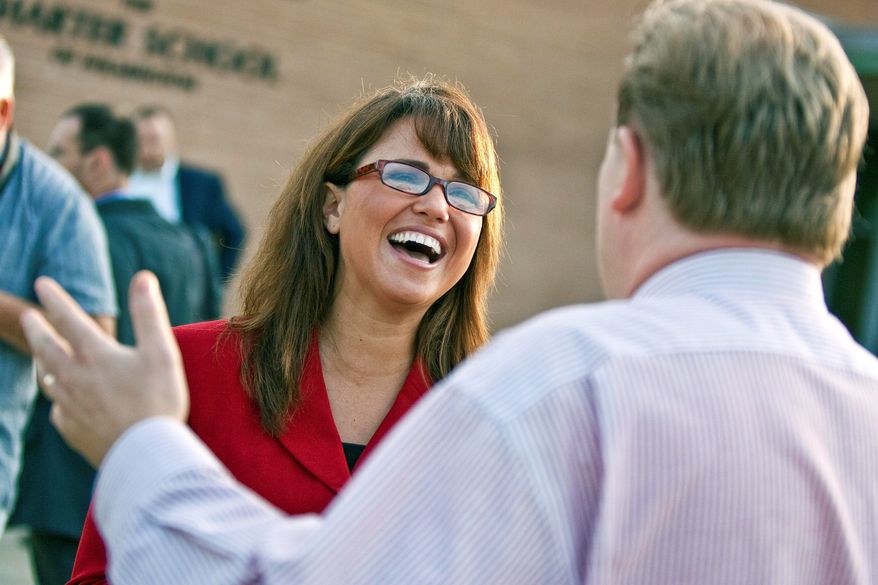 Associated Press
Senate candidate Christine O'Donnell chats with voters in Wilmington, Del., on Tuesday. Ms. O'Donnell took on nine-term Rep. Michael N. Castle in the Republican primary for a U.S. Senate seat.