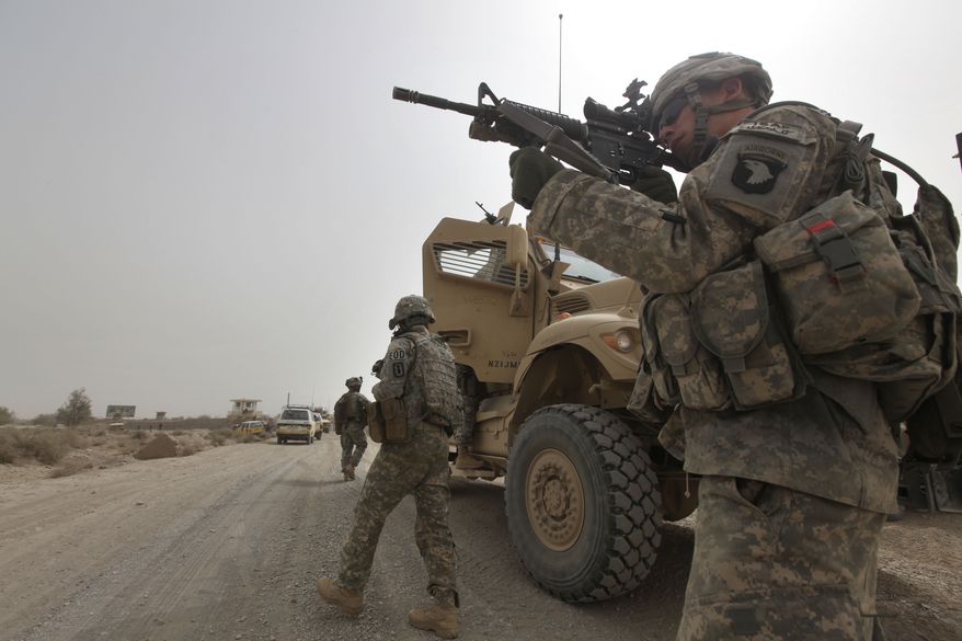 ** FILE ** U.S. Army Spc. Cody Borawa of Unadilla, N.Y., of Tactical Command Post, HQ Company, 2-502 Infantry, 101st Airborne Division, looks for a Taliban position during a day of joint missions with the Afghan army in the Zhari district of southern Afghanistan's Kandahar province on Aug. 26, 2010. (AP Photo/Brennan Linsley, File)