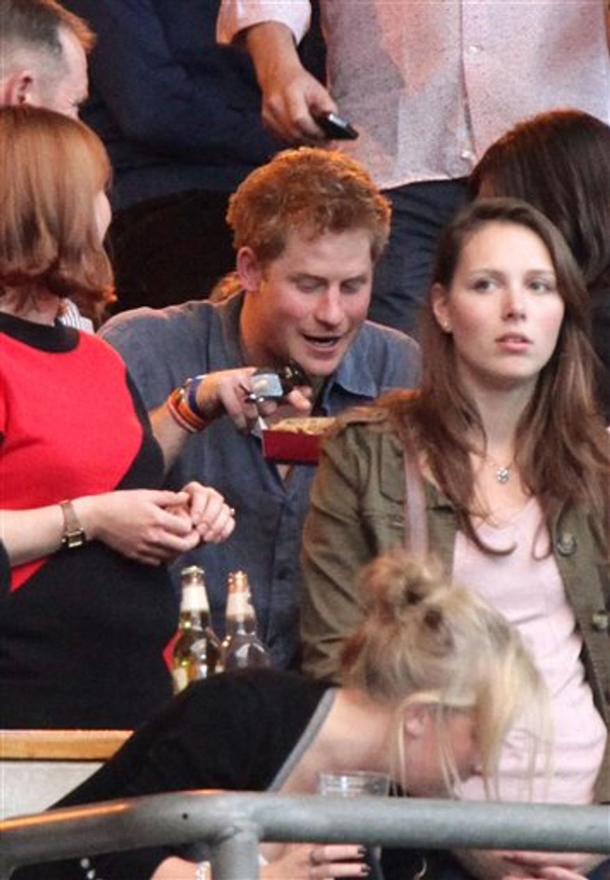 Britain's Prince Harry, center, attends the 'Help For Heroes' Concert at Twickenham Stadium, London Sunday Sept. 12, 2010. Some 60,000 concert goers will attend the concert in aid of the 'Help For Heroes' charity which supports members of Britain's armed forces. (AP Photo/Yui Mok/PA Wire)