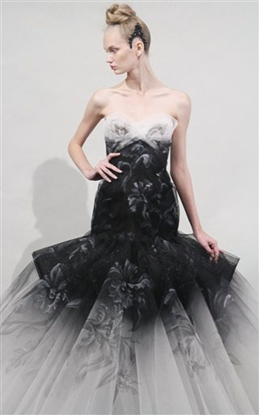 Stylists prepare a model backstage to present fashion from the Marchesa Spring 2011, Wednesday Sept. 15, 2010, during Fashion Week in New York. (AP Photo/Bebeto Matthews)