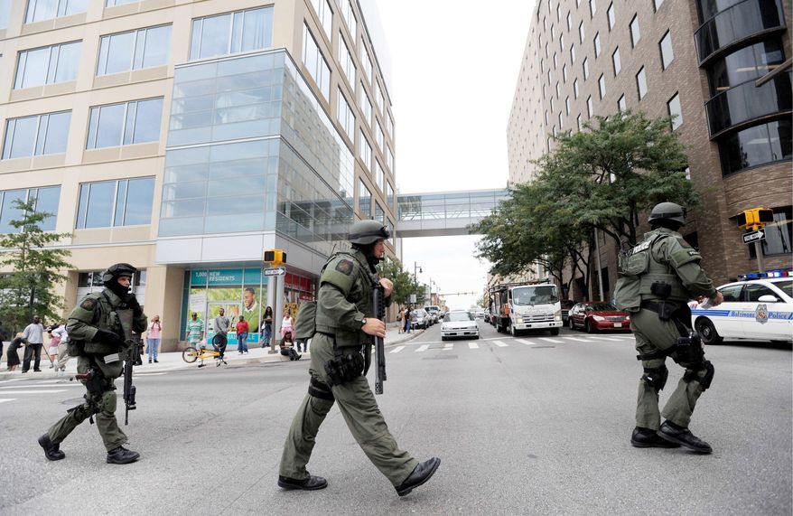 ASSOCIATED PRESS
Members of a Baltimore County SWAT team take up positions at Johns Hopkins Hospital in Baltimore on Thursday after a man shoots a doctor during a consultation. The surgeon survived but the gunman killed his ailing mother and himself in a hospital room before the standoff of more than two hours ended.