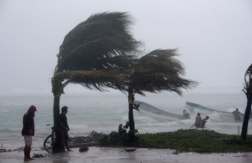 Fishermen try to secure their boats as tropical storm Karl arrives in the town of Mahahual, southern Mexico, Wednesday, Sept. 15, 2010. Karl is expected to quickly weaken into a tropical depression as it slogs across the flat peninsula before heading back out over the Gulf of Mexico, where it could turn into a hurricane by the end of the week and threaten the central Mexican coast. (AP Photo/Israel Leal)