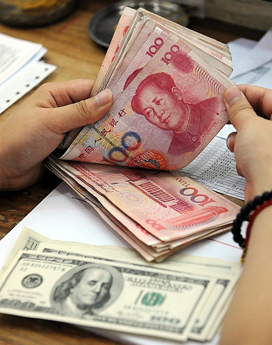A clerk counts Chinese yuan banknotes at a bank in Hefei, in central China's Anhui province, on Wednesday, Sept. 15, 2010. (AP Photo)