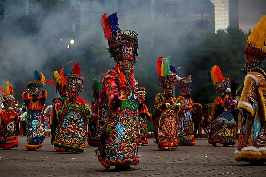 Chinelo dancers perform during the bicentennial parade in Mexico City, Wednesday Sept. 15, 2010. Mexico celebrates the 200th anniversary of its 1810 independence uprising. (AP Photo/Miguel Tovar)