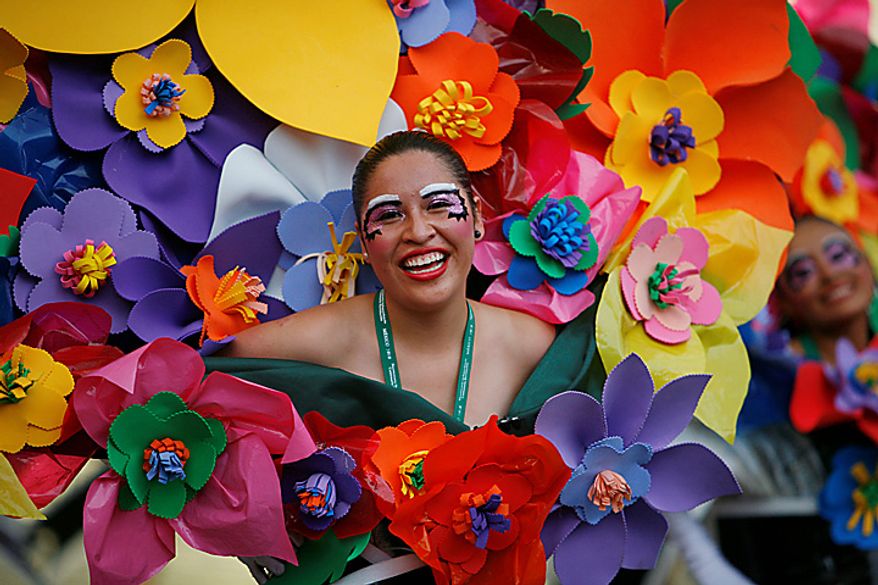 A dancer dressed as a bouquet of flowers performs during the bicentennial parade in Mexico City, Wednesday Sept. 15, 2010. Mexico celebrates the 200th anniversary of its 1810 independence uprising. (AP Photo/Miguel Tovar)