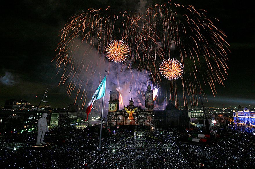 Fireworks explode over the Zocalo plaza during bicentennial celebrations in Mexico City, Wednesday Sept. 15, 2010. Mexico celebrates the 200th anniversary of its 1810 independence uprising. (AP Photo/Marco Ugarte)