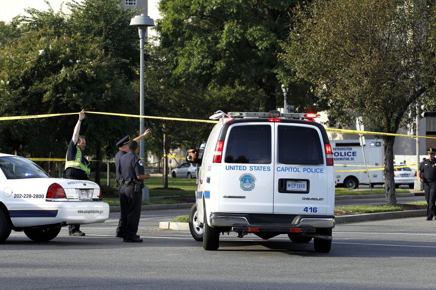 Police officers at the scene of a shooting on Capitol Hill in Washington on Friday, Sept. 17, 2010. Authorities in Washington say police shot a man who pointed a gun at them on Capitol Hill. (AP Photo/Jose Luis Magana)