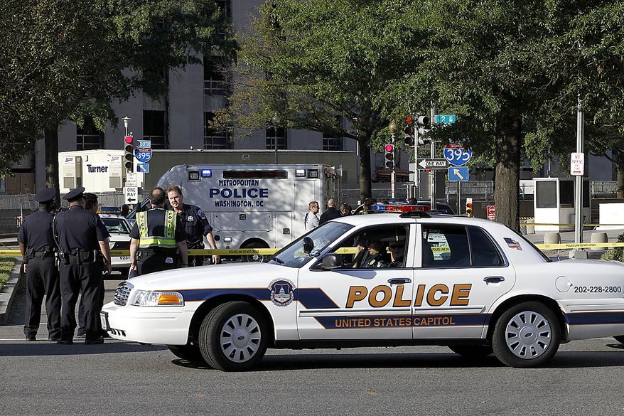Police officers at the scene of a shooting on Capitol Hill in Washington on Friday, Sept. 17, 2010. Authorities in Washington say police shot a man who pointed a gun at them on Capitol Hill. (AP Photo/Jose Luis Magana)