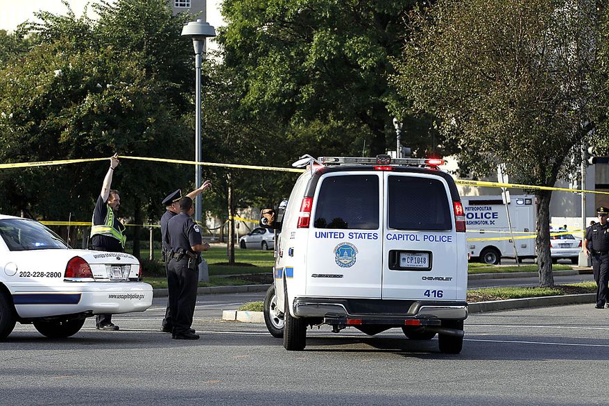 Police officers at the scene of a shooting on Capitol Hill in Washington on Friday, Sept. 17, 2010. Authorities in Washington say police shot a man who pointed a gun at them on Capitol Hill. (AP Photo/Jose Luis Magana)