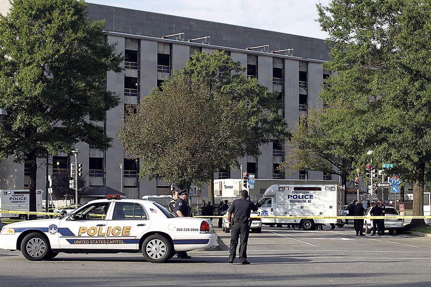 Police officers at the scene of a shooting on Capitol Hill in Washington on Friday, Sept. 17, 2010. Authorities in Washington say police shot a man who pointed a gun at them on Capitol Hill. (AP Photo/Jose Luis Magana)