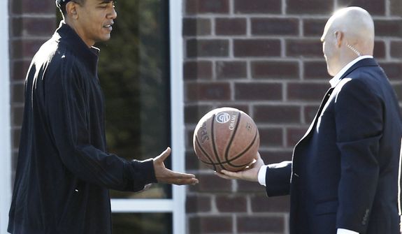 President Barack Obama is handed a personalized basketball by a military aide as he arrives for a private game of basketball at Fort McNair in Washington, Saturday, Sept. 18, 2010. (AP Photo/Charles Dharapak)