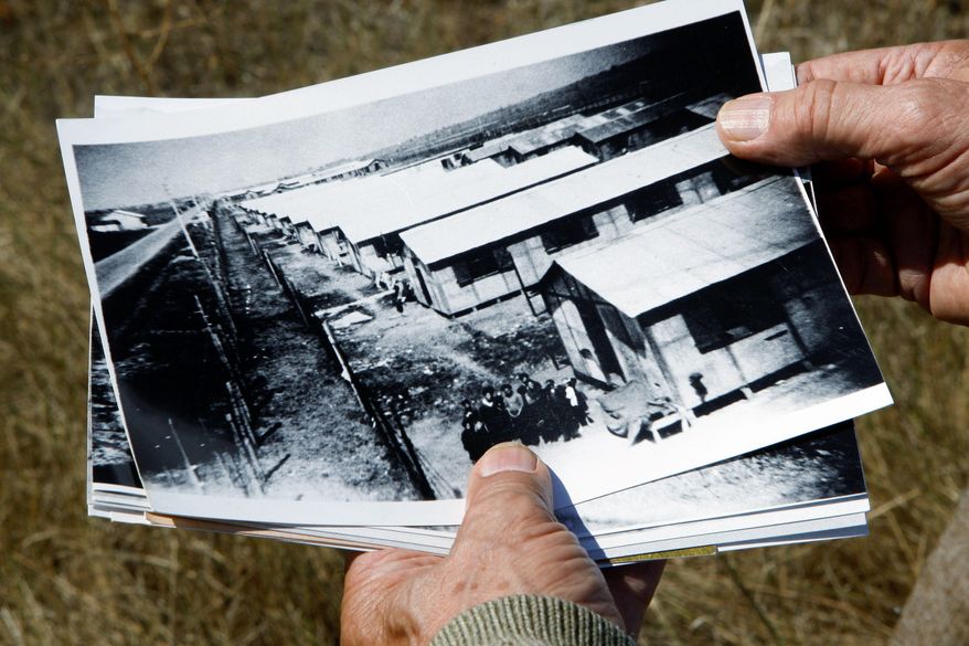 Retired schoolteacher Jacques Sigot shows photos taken of a camp in the village of Montreuil-Bellay where, during World War II, thousands of French Gypsies were interned.