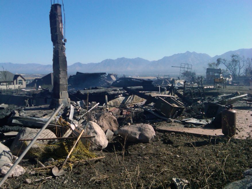 The remains of a burned house are seen on Monday, Sept. 20, 2010, in Harriman, Utah, after a fire swept though, destroying several homes overnight. A wind-stoked wildfire sparked at a firing range during a National Guard training session blazed across thousands of acres Monday. (AP Photo/Jennifer Dobner)