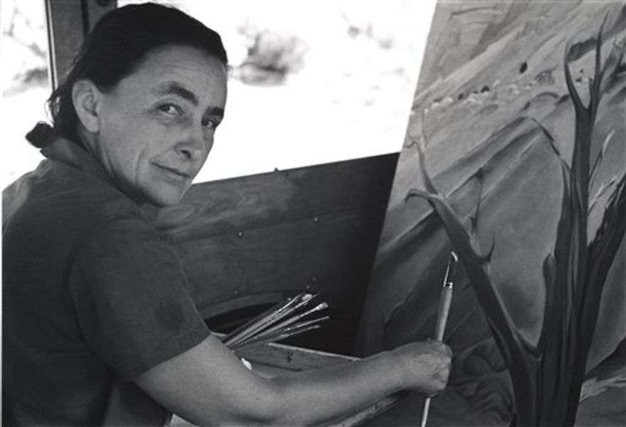 This 1960 image provided by the Georgia O'Keeffe Museum, Tony Vaccaro, shows American modernist painter Georgia O'Keeffe looking through a piece of cheese. A new exhibition, "O'Keeffiana: Art and Art Materials," opens at the Georgia O'Keeffe Museum in Santa Fe, N.M., on Sept. 24, 2010. It includes O'Keeffe's art supplies, drawings, unfinished paintings and the rocks and bleached animal bones she used as subjects. (AP Photo/Tony Vaccaro, courtesy of the Georgia O'Keeffe Museum) NO SALES